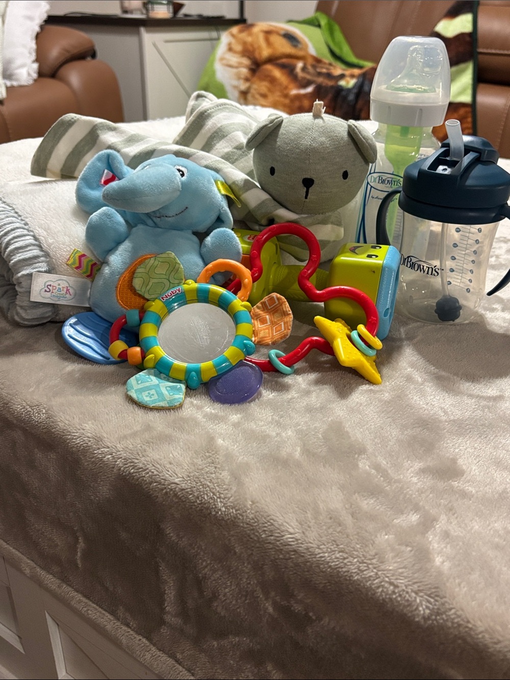 Box of infant toys, Dr. Brown bottle & sippy, plush blanket, baby spoons